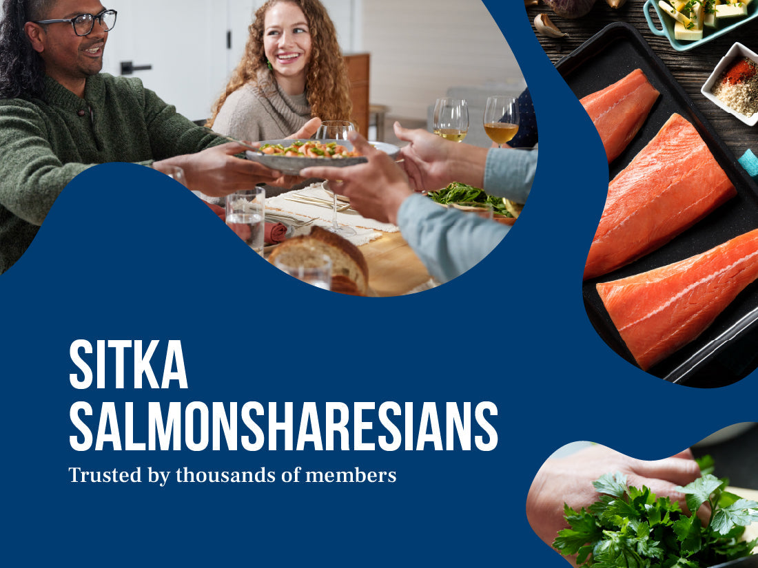 People enjoying a meal with salmon and greens